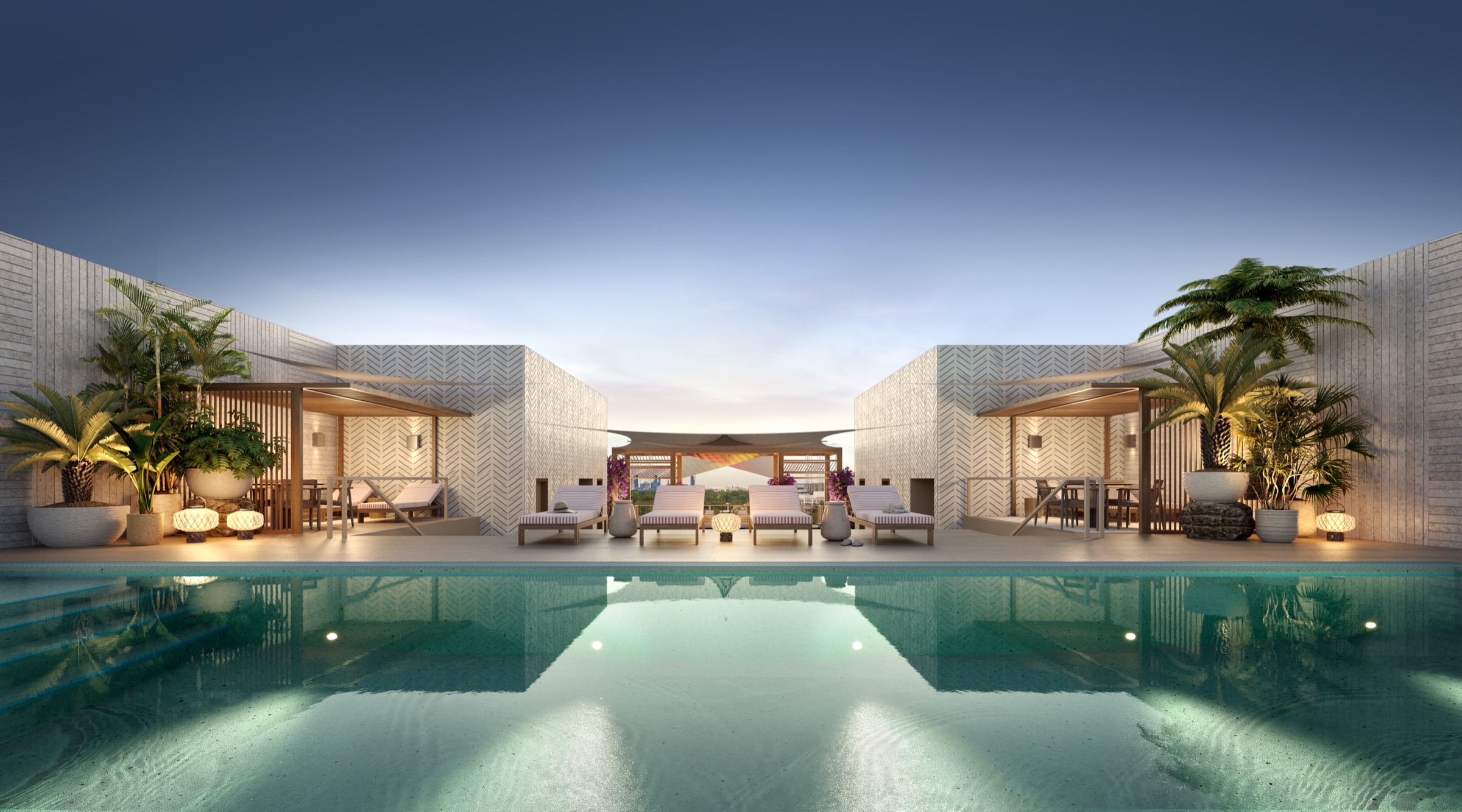 Rooftop pool at dusk at The Lincoln Coconut Grove Residences — atmospheric lighting, lounge seating, panoramic views over the Coconut Grove canopy.